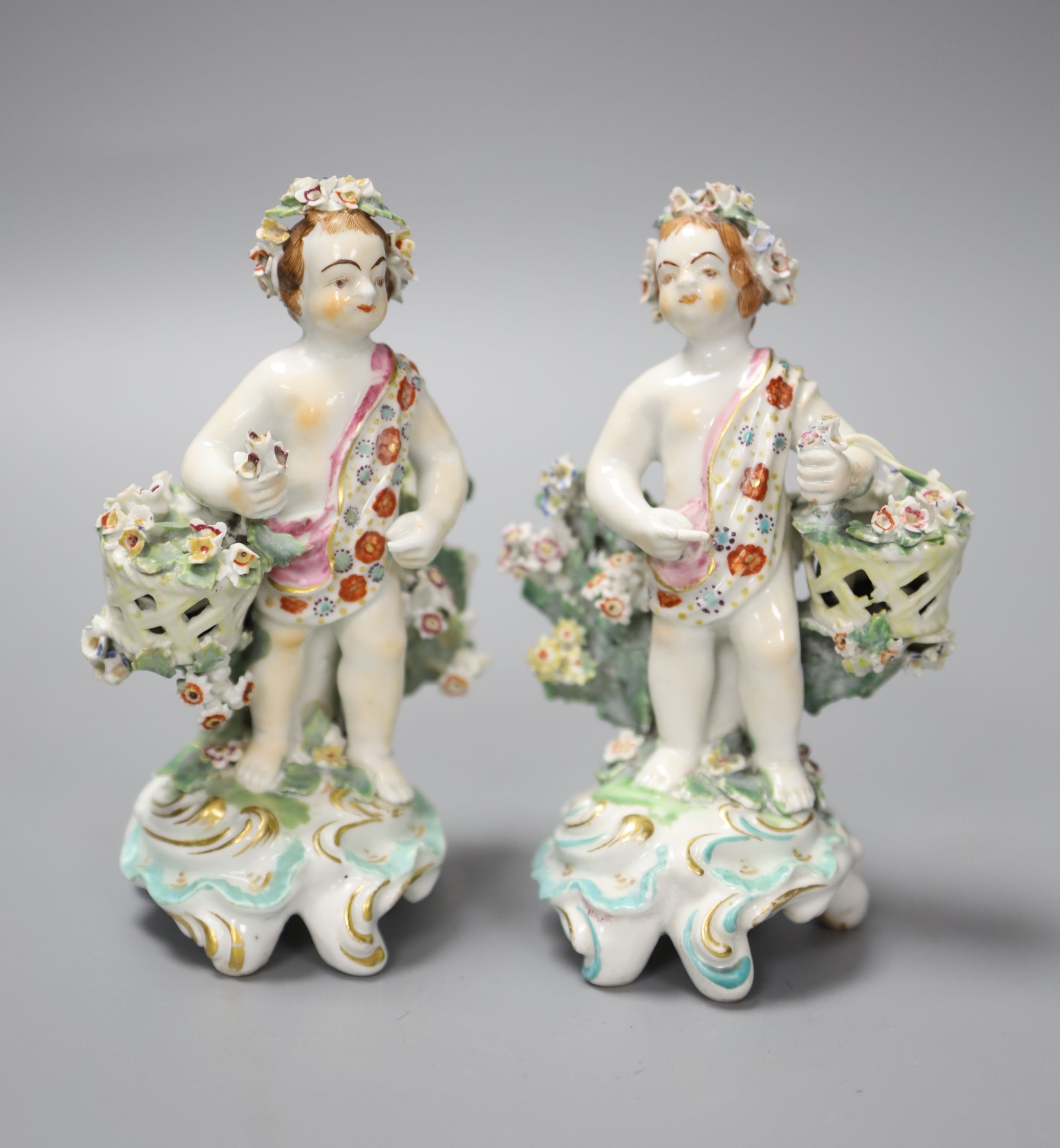 A pair of 18th century Derby figures of children holding baskets, height 12.5cm